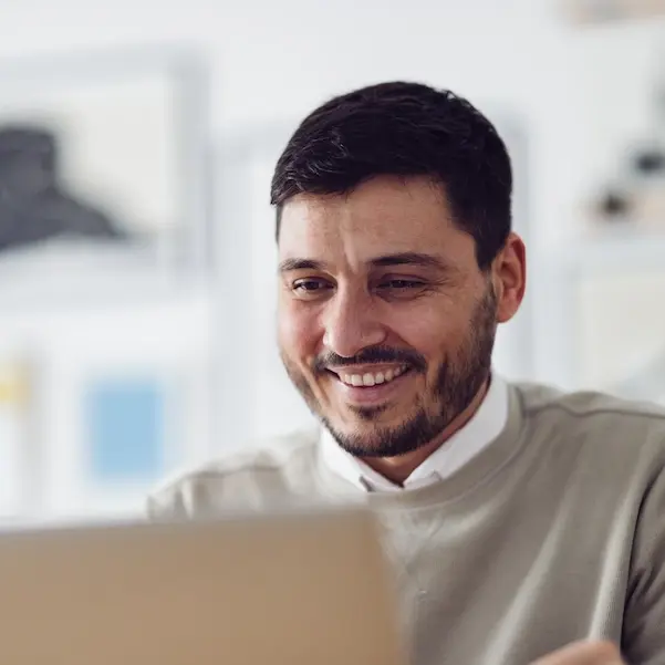 Happy man working on a laptop