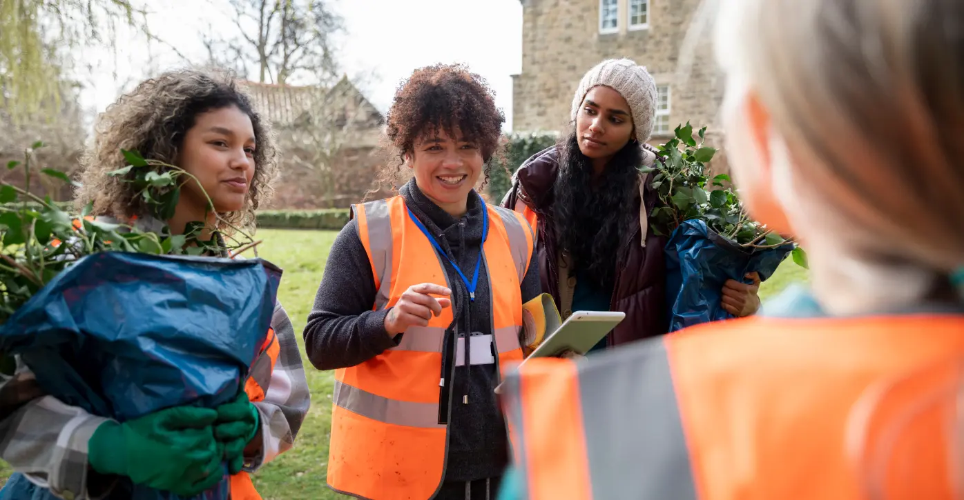 Group Of Happy People Planning In High Visibility Vests