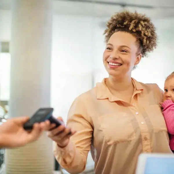 Mum with baby paying with mobile