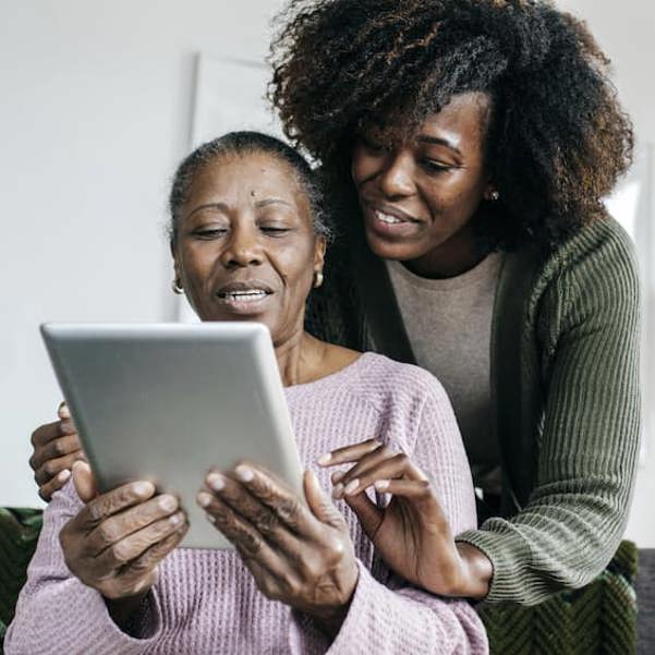 Senior in assisted home holding a digital ipad